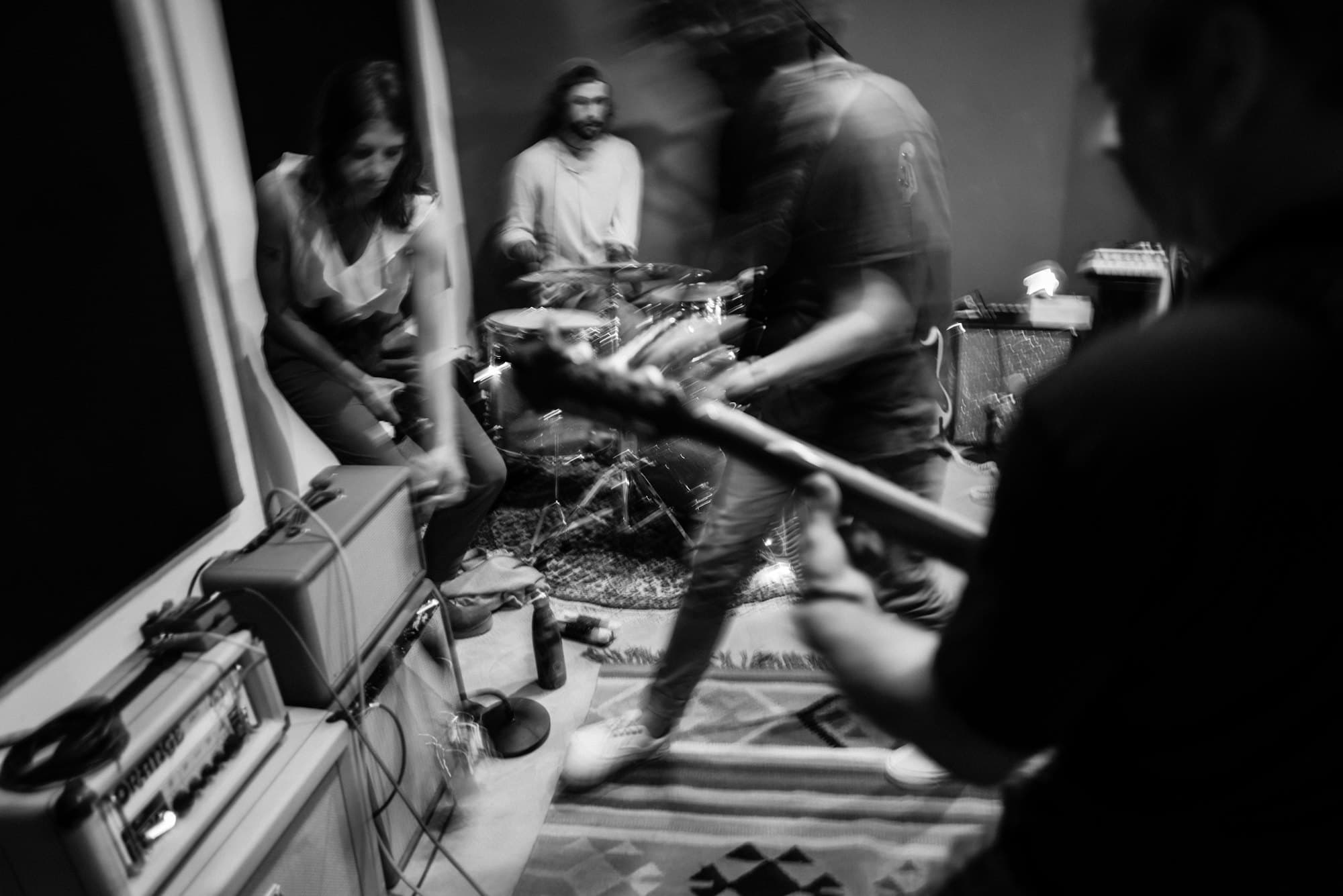 A band playing together in a small room